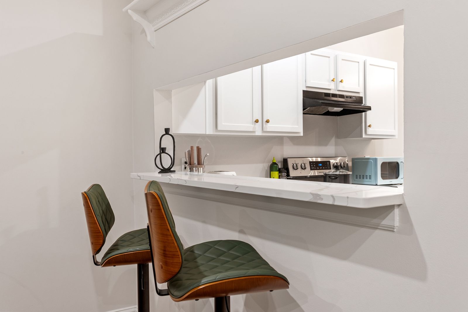 Breakfast bar with two green leather stools