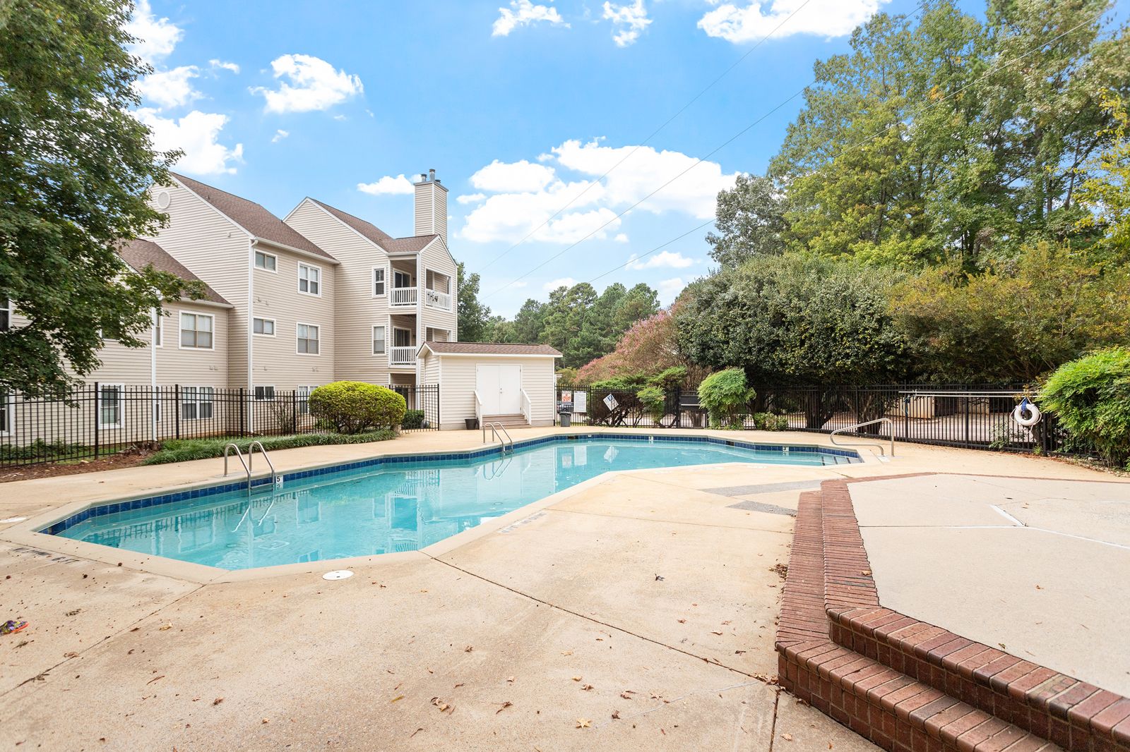Community pool surrounded by trees