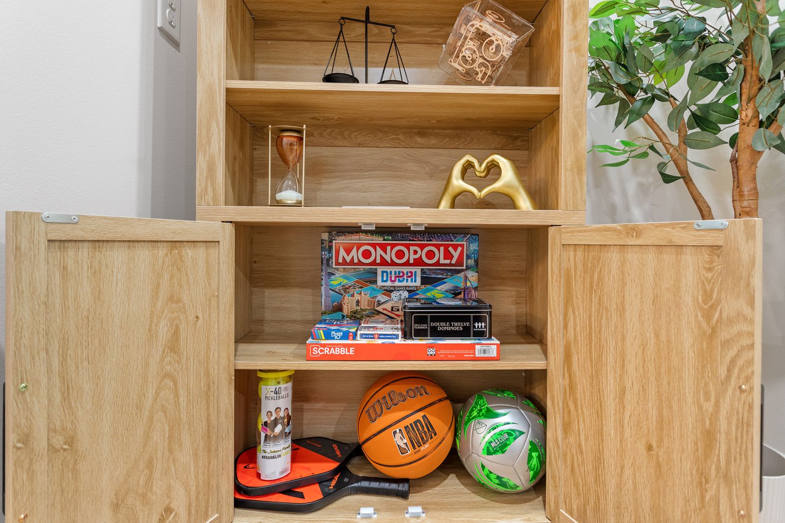 Cabinet with board games and sports balls