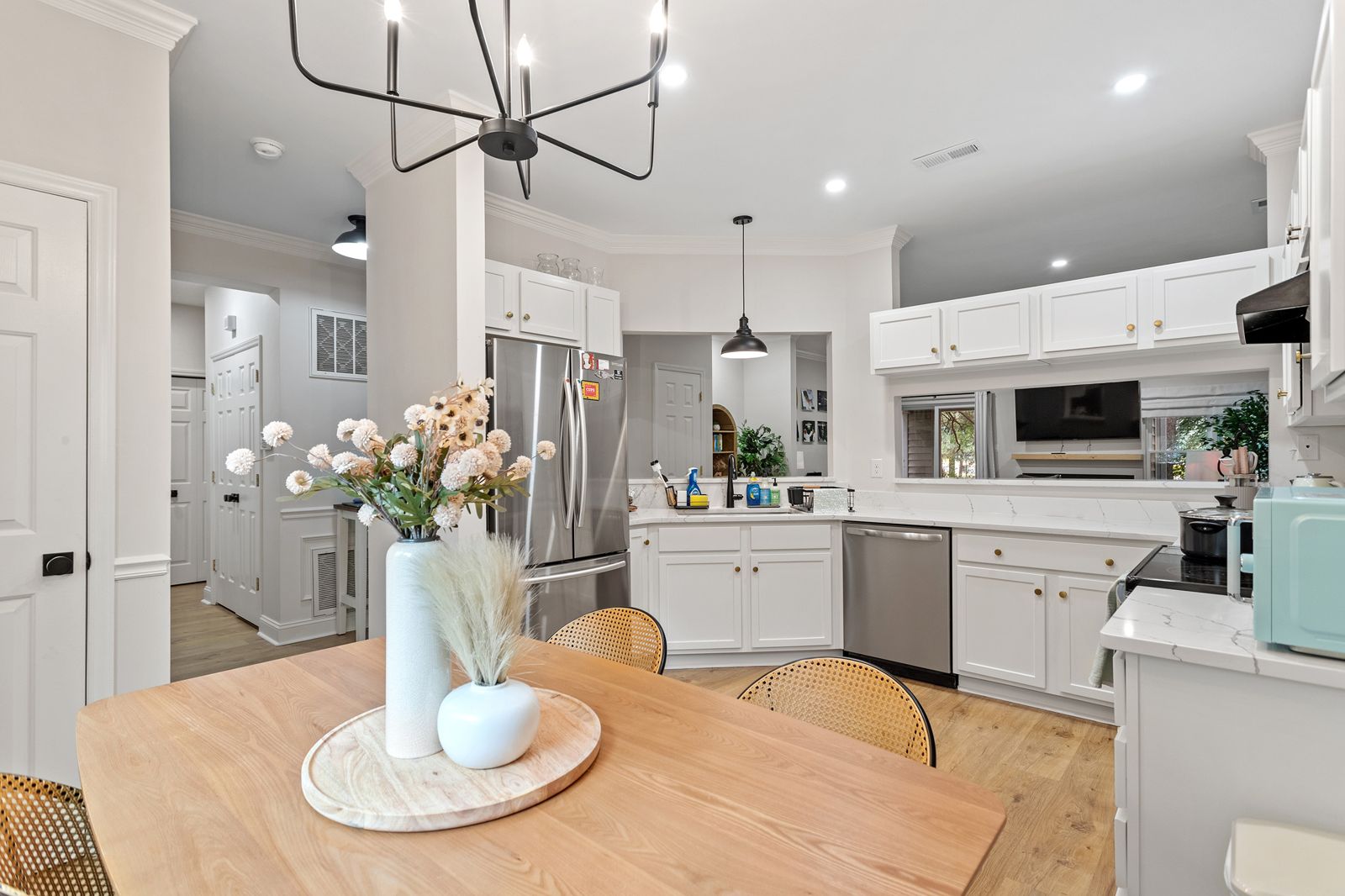 Kitchen with stainless French-door fridge, dishwasher and white cabinets