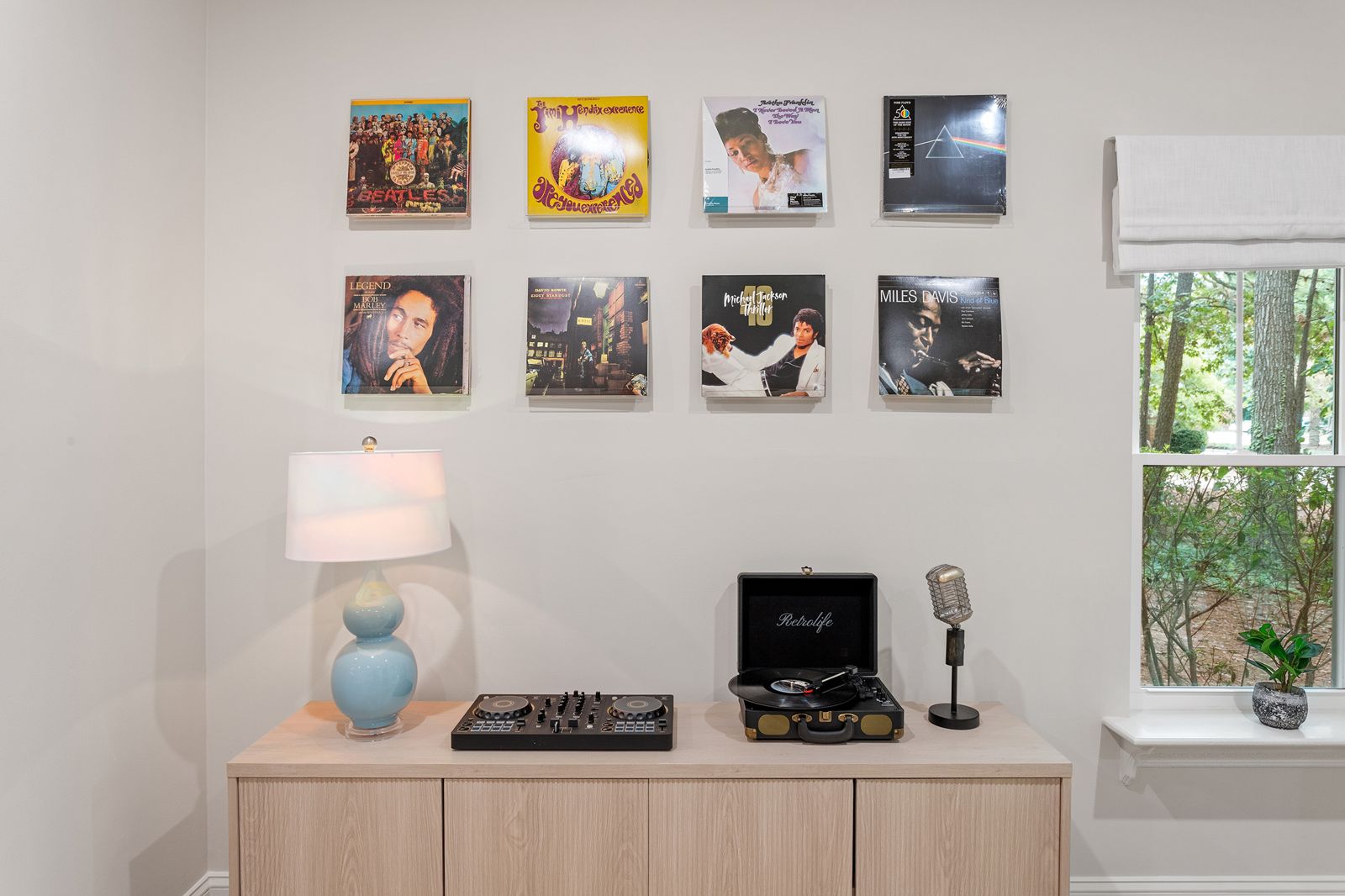 Record player and vinyl albums displayed on the living room wall