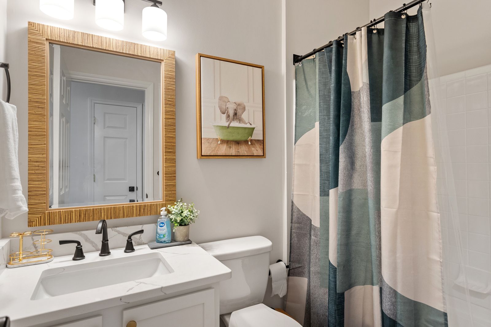 Second bathroom with quartz vanity and tub with shower