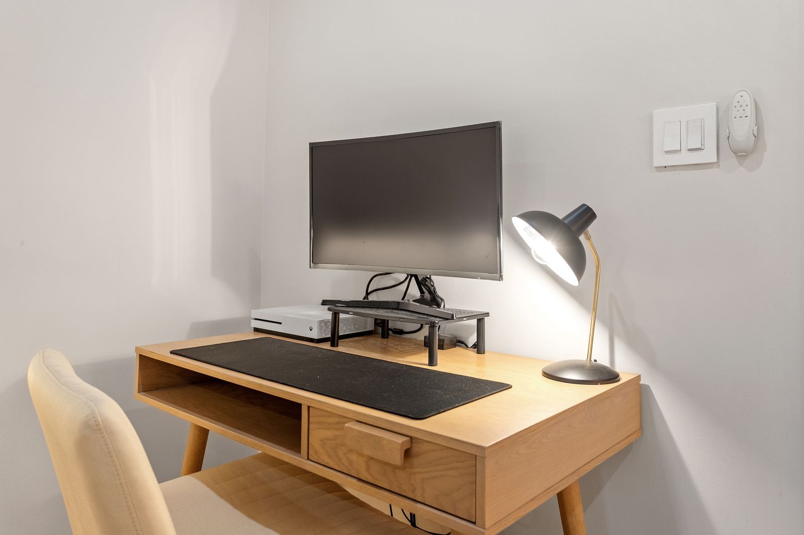 Desk with a curved monitor and desk lamp